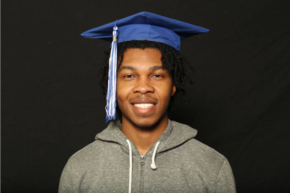 student wearing his graduate cap up close